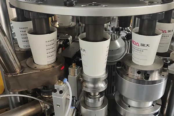 Cup bottom heating and sealing system